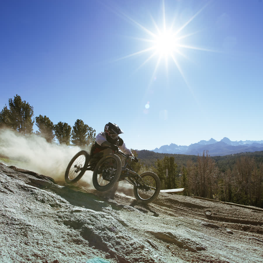 Adaptive mountain bike rider descending a sunlit ridge, Active Force Foundation